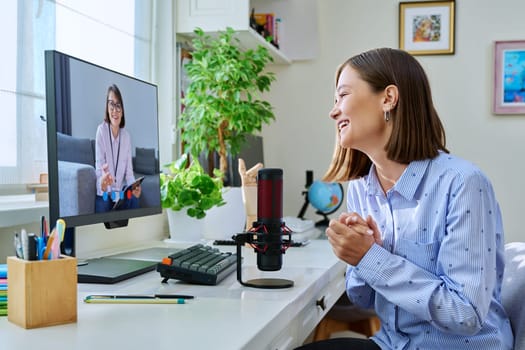 Online mental therapy, remote meeting of young woman sitting at desk at home with psychologist, counselor, therapist, social worker, using pc computer. Psychology, psychotherapy, support, treatment