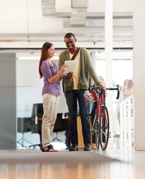 People, talking and tablet in office with bicycle for travel or morning commute to workplace. Bike messenger, logistics and discussion of business, project or checklist with employees and client.