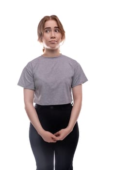 A teenage girl with brown hair looks thoughtfully to the side.