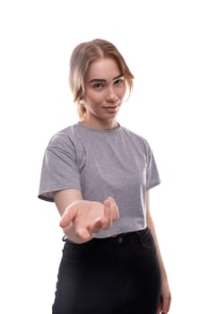 Surprised teenage schoolgirl with brown hair extends her hand.