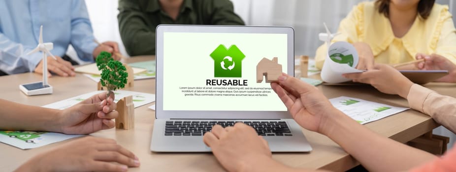 Reusable sign displayed on green business laptop while business team presenting green design to customer. ESG environment social governance and Eco conservative concept. Closeup. Delineation