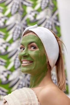 beautiful woman with green alginate mask on face