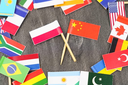 Policy. National flags of different countries. The concept is diplomacy. In the middle among the various flags are two flags - China, Poland