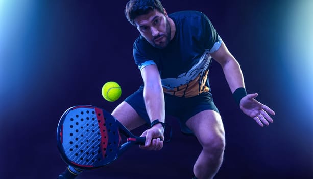 Padel tennis player with racket. Man athlete with racket on court with neon colors. Sport concept. Download a high quality photo for the design of a sports app or betting site