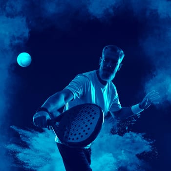 Padel tennis player with racket. Man athlete with racket on court with neon colors. Sport concept. Download a high quality photo for the design of a sports app or betting site