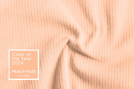 Peach Fuzz color of the year 2024. Waved ribbed cotton fabric texture pastel orange color . Close up rib cotton cloth and textiles pattern. Natural organic fabrics texture background