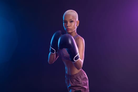 The Boxing. Brazilian woman boxer. Sportsman muay thai boxer fighting in gloves. Isolated on black background. Copy Space