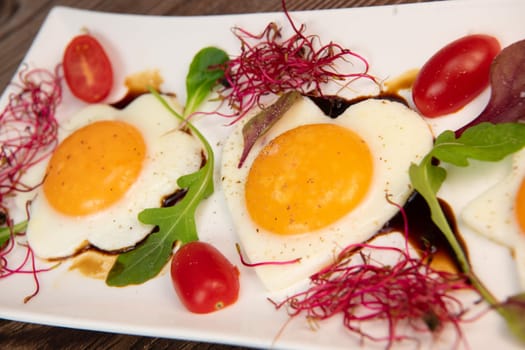 RECIPE FOR FRIED EGGS AND POMEGRANATE MOLASSES CUT INTO HEARTS, STARS AND FLOWERS. High quality photo