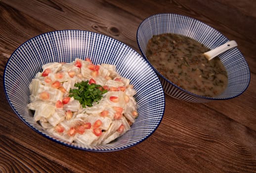 LEBANESE RECIPE FOR CHARD SOUP, LENTILS WITH LEMON, ADAS BI HAMOUD AND CHARD CHOPS, SESAME CREAM, TAHINI, POMEGRANATE SEEDS. High quality photo