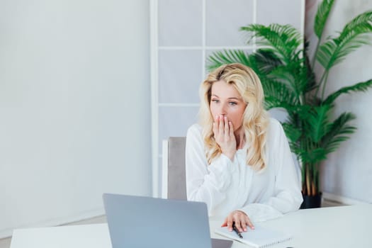 Business woman in office at laptop business online