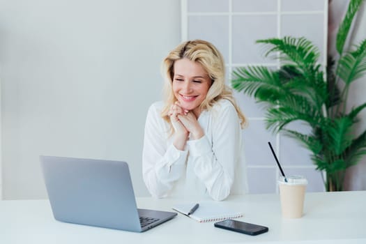Woman in office at laptop business online