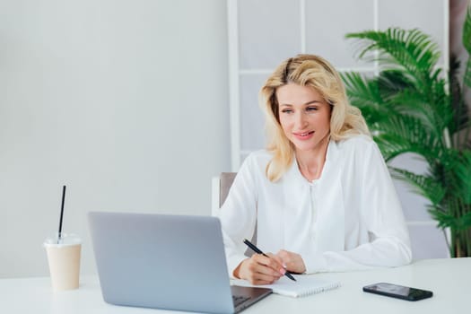 Woman in office at laptop business online