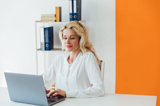 Businesswoman in office at laptop small business online