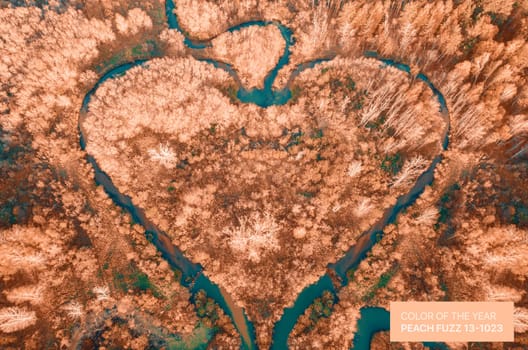 Heart shaped river aerial drone view. Colored in Peach fuzz color