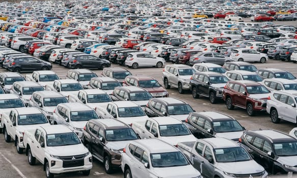 Lamchabang, Thailand - July 02, 2023 In a crowded car factory warehouse, numerous brand new vehicles await exporta vivid representation of modern automotive manufacturing.