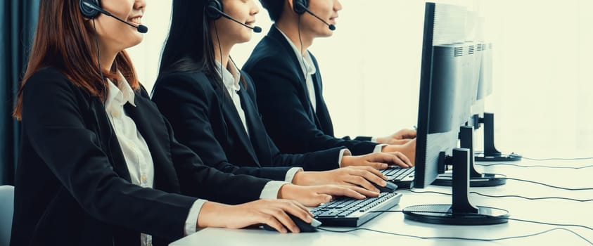 Business people wearing headset working in office to support remote customer or colleague. Call center, telemarketing, customer support agent provide service on telephone video conference oratory call