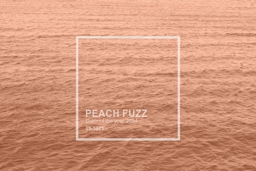 Peach Fuzz toned sea water texture. Pool water with sun reflections. Trendy colour 2024 year. High quality photo