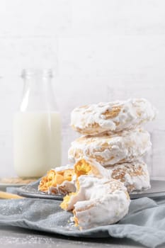 Sweet portuguese donuts with white glaze. Donuts baked at home. Simple and tasty dessert.