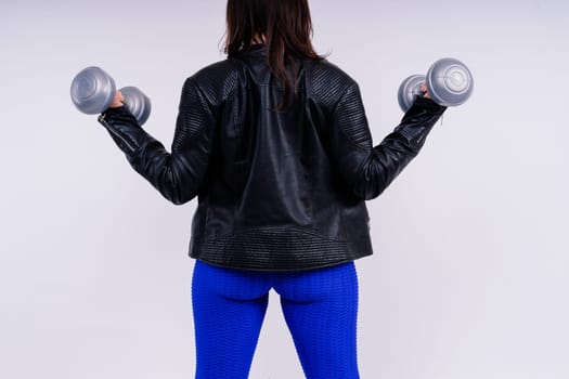 Young smiling happy chubby overweight plus size big fit woman warm up training hold dumbbells