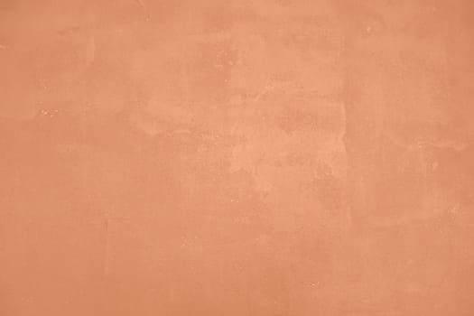 Peach Fuzz toned colour grunge decorative wall background. Art rough stylized texture banner trendy color 2024. Grunge Peach Fuzz color texture. High quality photo