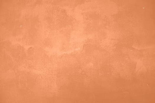 Peach Fuzz toned colour grunge decorative wall background. Art rough stylized texture banner trendy color 2024. Grunge Peach Fuzz color texture. High quality photo