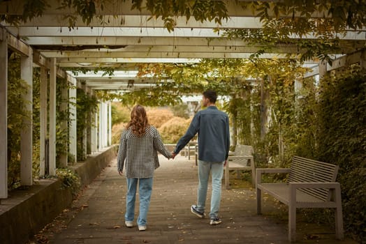 Young Cute Female Hugs Boyfriend. In Autumn Outdoor. Lovers Walking in Park. Attractive Funny Couple. Lovestory in Forest. Man and Woman. Cute Lovers in the Park. Family Concept. Happy Couple.