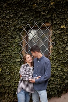 Young Cute Female Hugs Boyfriend. In Autumn Outdoor. Lovers Walking in Park. Attractive Funny Couple. Lovestory in Forest. Man and Woman. Cute Lovers in the Park. Family Concept. Happy Couple.