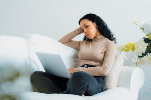 Young African-American woman feels depressed while looking at crucial work in laptop computer