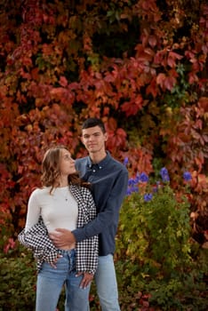 Young Cute Female Hugs Boyfriend. In Autumn Outdoor. Lovers Walking in Park. Attractive Funny Couple. Lovestory in Forest. Man and Woman. Cute Lovers in the Park. Family Concept. Happy Couple.