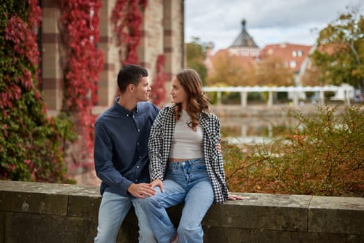 Young Cute Female Hugs Boyfriend. In Autumn Outdoor. Lovers Walking in Park. Attractive Funny Couple. Lovestory in Forest. Man and Woman. Cute Lovers in the Park. Family Concept. Happy Couple.