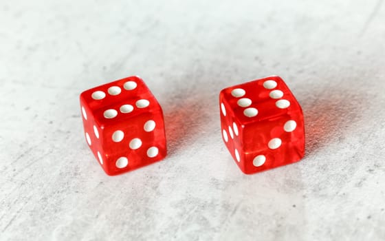 Two translucent red craps dices on white board showing Boxcars or Midnight (double number 6)