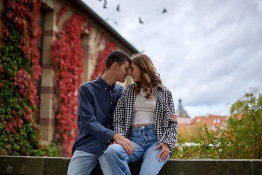 Young Cute Female Hugs Boyfriend. In Autumn Outdoor. Lovers Walking in Park. Attractive Funny Couple. Lovestory in Forest. Man and Woman. Cute Lovers in the Park. Family Concept. Happy Couple.