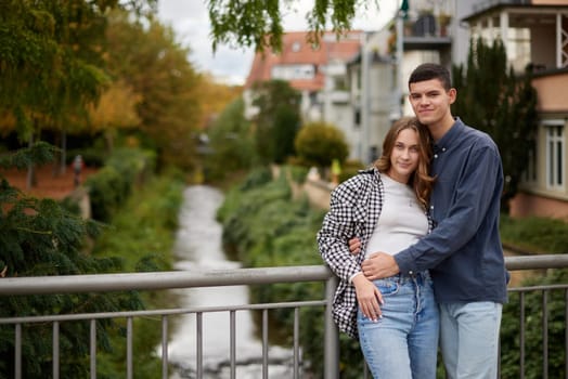 Young Cute Female Hugs Boyfriend. In Autumn Outdoor. Lovers Walking in Park. Attractive Funny Couple. Lovestory in Forest. Man and Woman. Cute Lovers in the Park. Family Concept. Happy Couple.