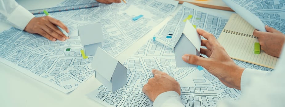 Worker, architect and engineer work on real estate construction project oratory planning with cartography and cadastral map of urban town area to guide to construction developer business plan of city