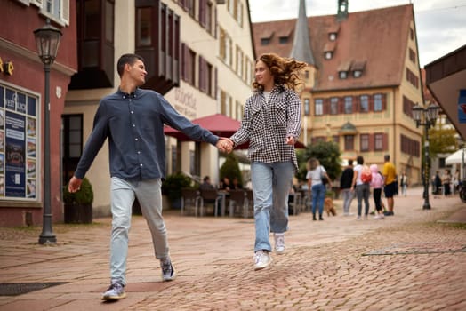 Young Cute Female Hugs Boyfriend. In Autumn Outdoor. Lovers Walking in Park. Attractive Funny Couple. Lovestory in Forest. Man and Woman. Cute Lovers in the Park. Family Concept. Happy Couple.