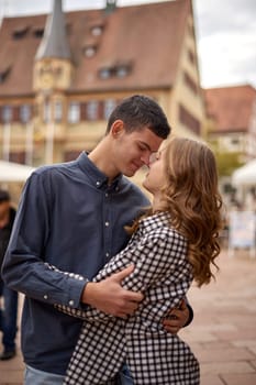 Young Cute Female Hugs Boyfriend. In Autumn Outdoor. Lovers Walking in Park. Attractive Funny Couple. Lovestory in Forest. Man and Woman. Cute Lovers in the Park. Family Concept. Happy Couple.