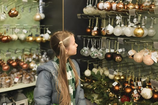 A girl choose the toys for the Christmas tree