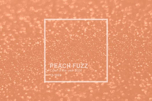 Peach Fuzz color glitter background. Blurred monochrome background with bokeh. Blurred glitters shimmering dust macro close up. High quality photo