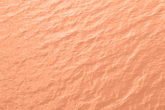 Peach Fuzz toned sea water texture. Pool water with sun reflections. Trendy colour 2024 year. High quality photo