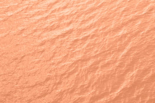 Peach Fuzz toned sea water texture. Pool water with sun reflections. Trendy colour 2024 year. High quality photo