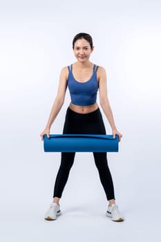 Young attractive asian woman portrait in sportswear with exercising mat. Healthy exercise and workout routine lifestyle concept. Studio shot isolated background. Vigorous