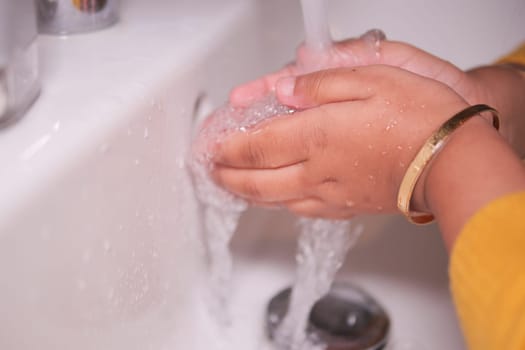 child washing hands with soap .