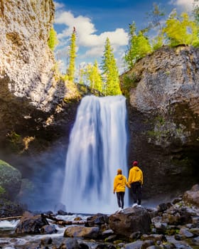 Moul Falls Canada a Beautiful waterfall in Canada, a couple of men and a woman visit Moul Falls, the most famous waterfall in Wells Gray Provincial Park.