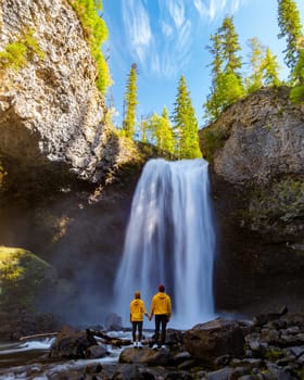 Moul Falls Canada a Beautiful waterfall in Canada British Columbia, a couple of men and a woman visit Moul Falls, the most famous waterfall in Wells Gray Provincial Park.