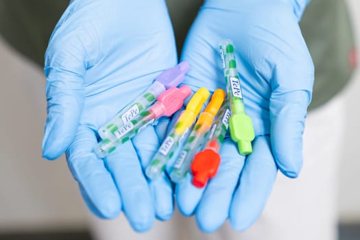 Teeth brushes in dentists hands in rubber gloves, December 2023, Prague, Czech Republic