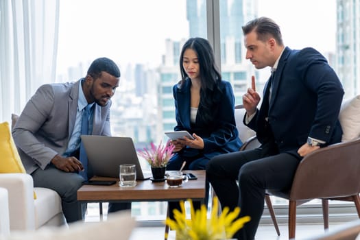 African businessman present start up project to expert investor. Group of multicultural business team solving problems, discussing business idea with skyscraper at modern business lounge. Ornamented