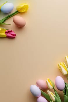 Colorful tulips and eggs lying on teal beige background with copy space for easter celebration