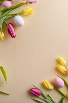 Colorful tulips and eggs lying on teal beige background with copy space for easter celebration