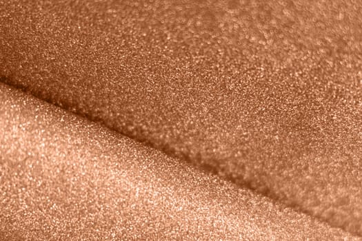 Peach fuzz, color of the year 2024 wave shiny glitter paper texture. Shining luxurious fabric. Glimmering golden color, christmas background