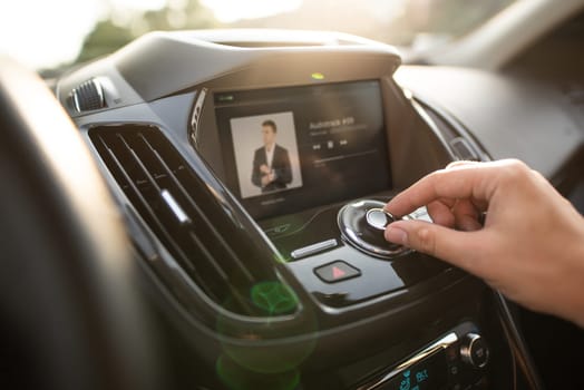 Man using car multimedia audio system. Internet car radio with touchscreen